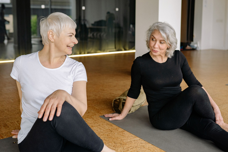 mullen residences two senior woman stretching in an exercise class
